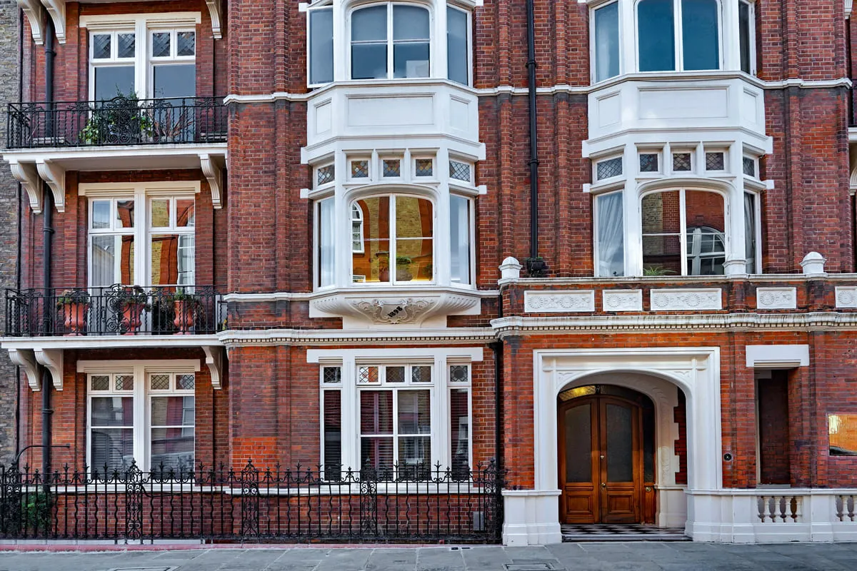a large red brick building, representing private client insurance
