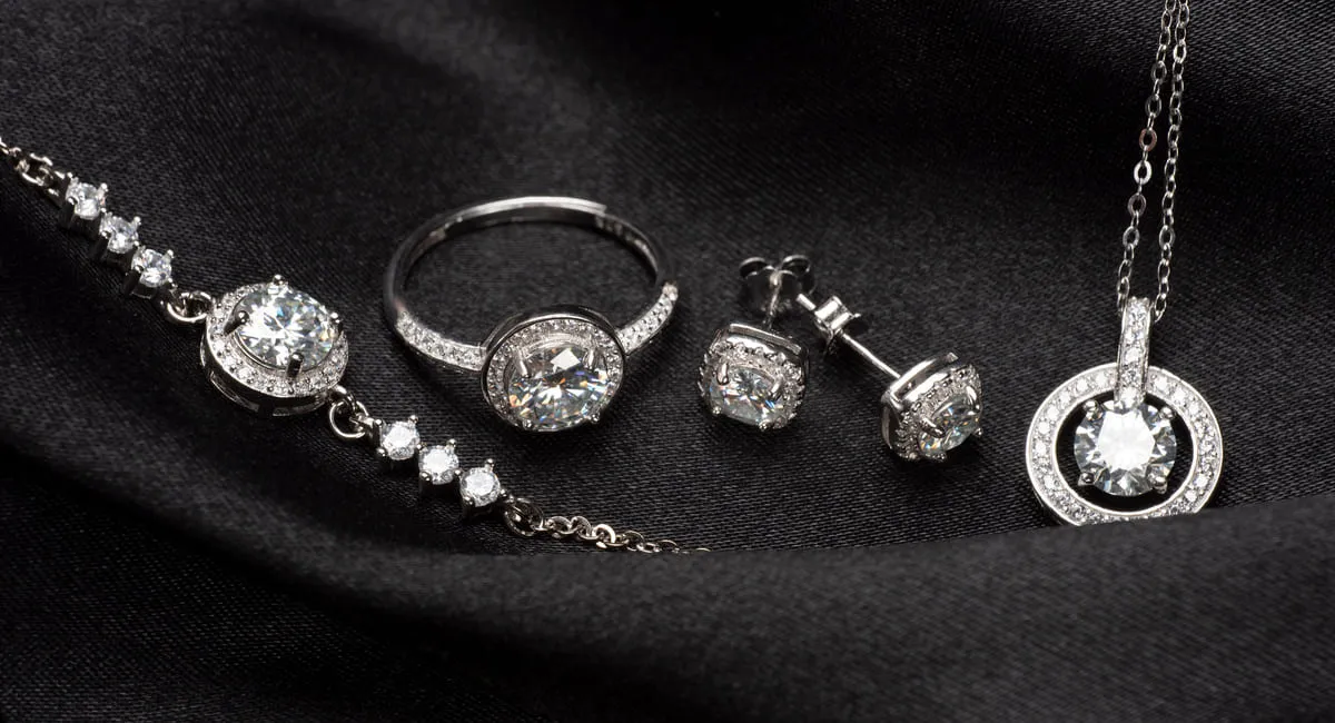 silver jewellery on a black cloth, representing private client insurance